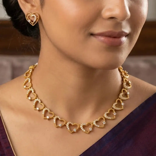 Victorian Antique Gold Stone Heart Necklace Set displayed on a model, featuring heart-shaped links and sparkling stones.