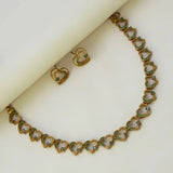 Victorian Antique Gold Stone Heart Necklace Set featuring heart-shaped links and green stones, elegantly displayed with matching earrings.