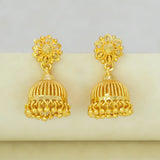 Gold earrings with intricate designs on a light gray background