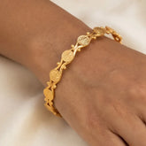 Gold Plated Ethnic Lakshmi Kasu Bangle worn on a wrist, showcasing intricate goddess-engraved coin designs.