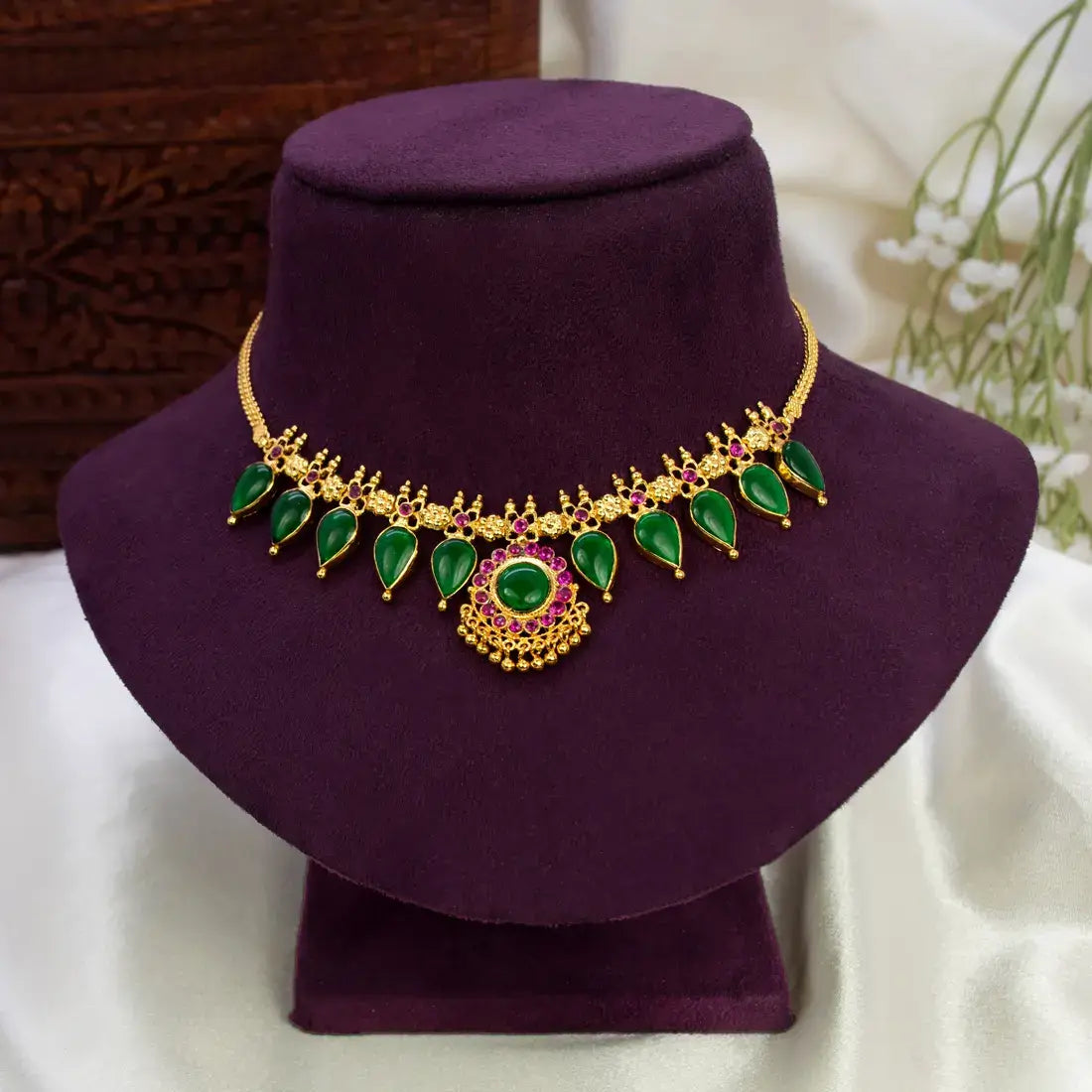 Kerala Traditional Gold-Plated Gopi Necklace featuring green enamel stones and intricate gold motifs.