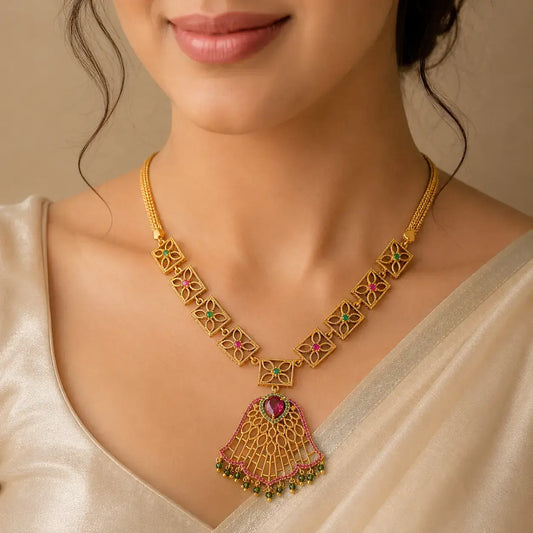 A close-up of a woman wearing a Victorian Antique Ruby Emerald Floral Necklace, decorated with pink and green stones.