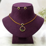 Victorian Gold-Plated Stone Necklace & Earring Set with green stones, displayed on a purple velvet jewelry bust against a light fabric background.