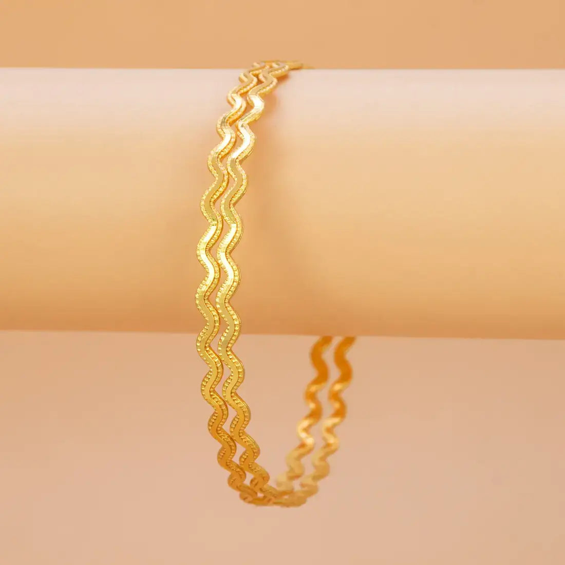 Unique Gold Plated Zigzag Bangles displayed on a neutral background, showcasing the undulating wave form and micro-bead texture.