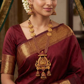 Antique Kemp Lakshmi Temple Long Necklace Set worn with matching jhumkas, perfect for weddings and festive occasions.