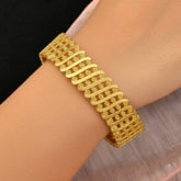 Elegant Gold Plated Floral Designer Bangle for Women on a wrist, showcasing intricate floral design.