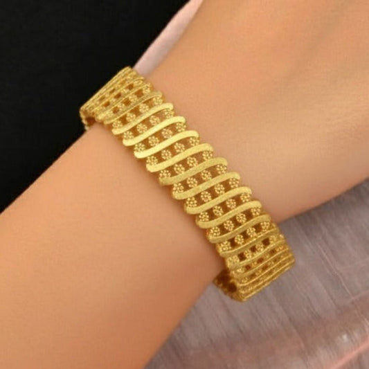 Elegant Gold Plated Floral Designer Bangle for Women on a wrist, showcasing intricate floral design.