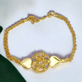Gold bracelet with floral design on a white background