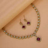 K Supreme gold-plated necklace and earrings set with peacock motifs and ruby red cubic zirconia stones.
