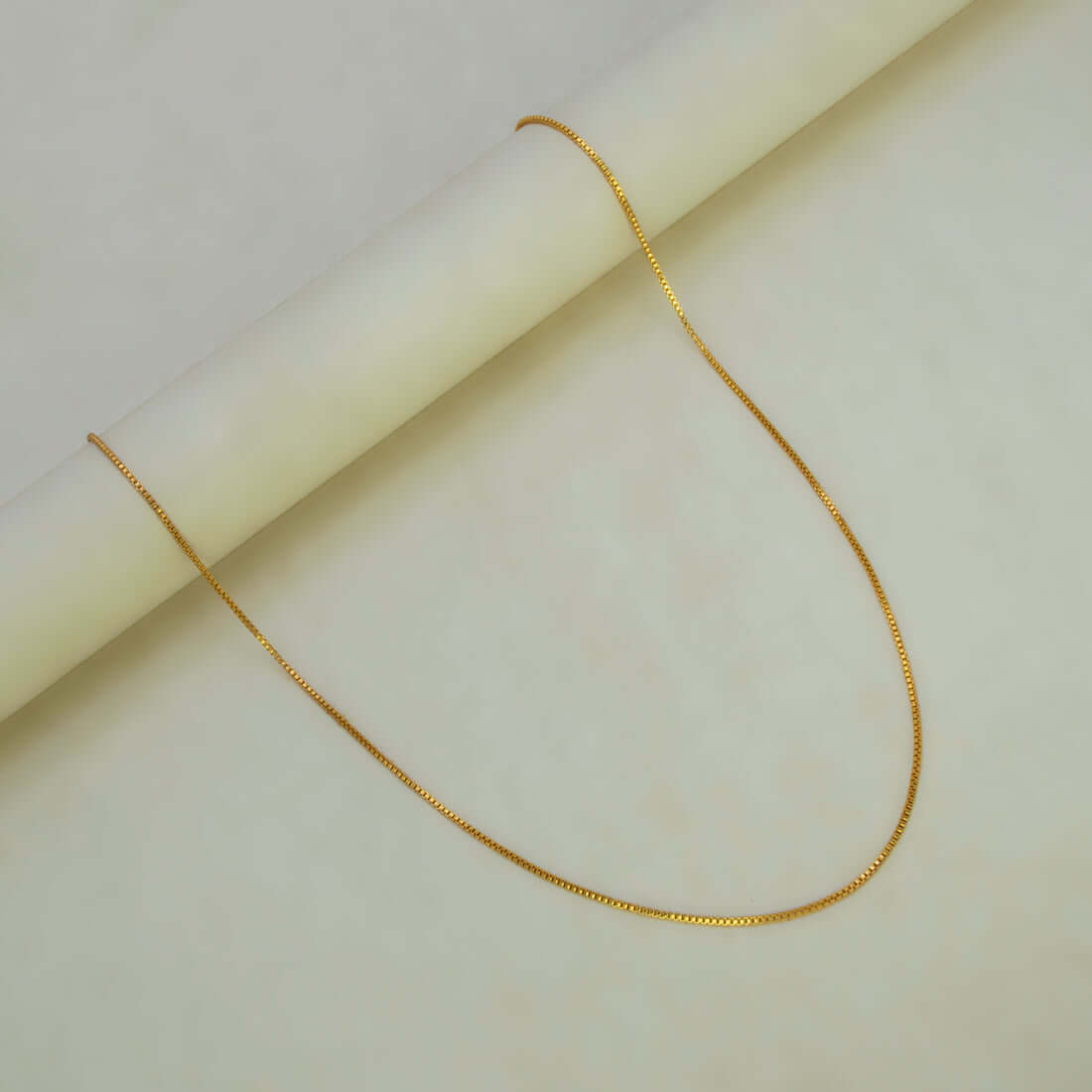 Aesthetic Gold Plated Thin Box Chain For Women displayed elegantly against a light background.
