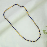 Alternating blue crystal and golden bead chain for women with faceted blue and gold round beads in a precise striped pattern
