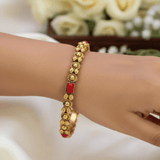 Antique Gold-Plated Coral Red Stone Bangle worn on wrist, showcasing intricate beadwork and coral red stones.