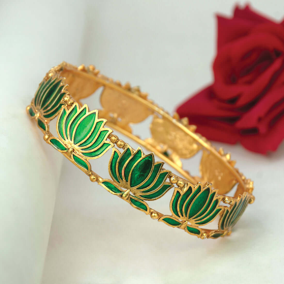 Matte Gold Plated Lotus Enamel Bangle showcasing green lotus motifs on a gold base, perfect for festive occasions.