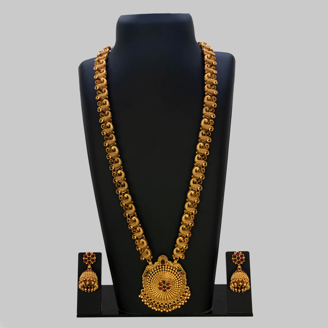 Antique Gold Peacock Kemp Stone Long Chain Necklace Set displayed on a bust with matching earrings.