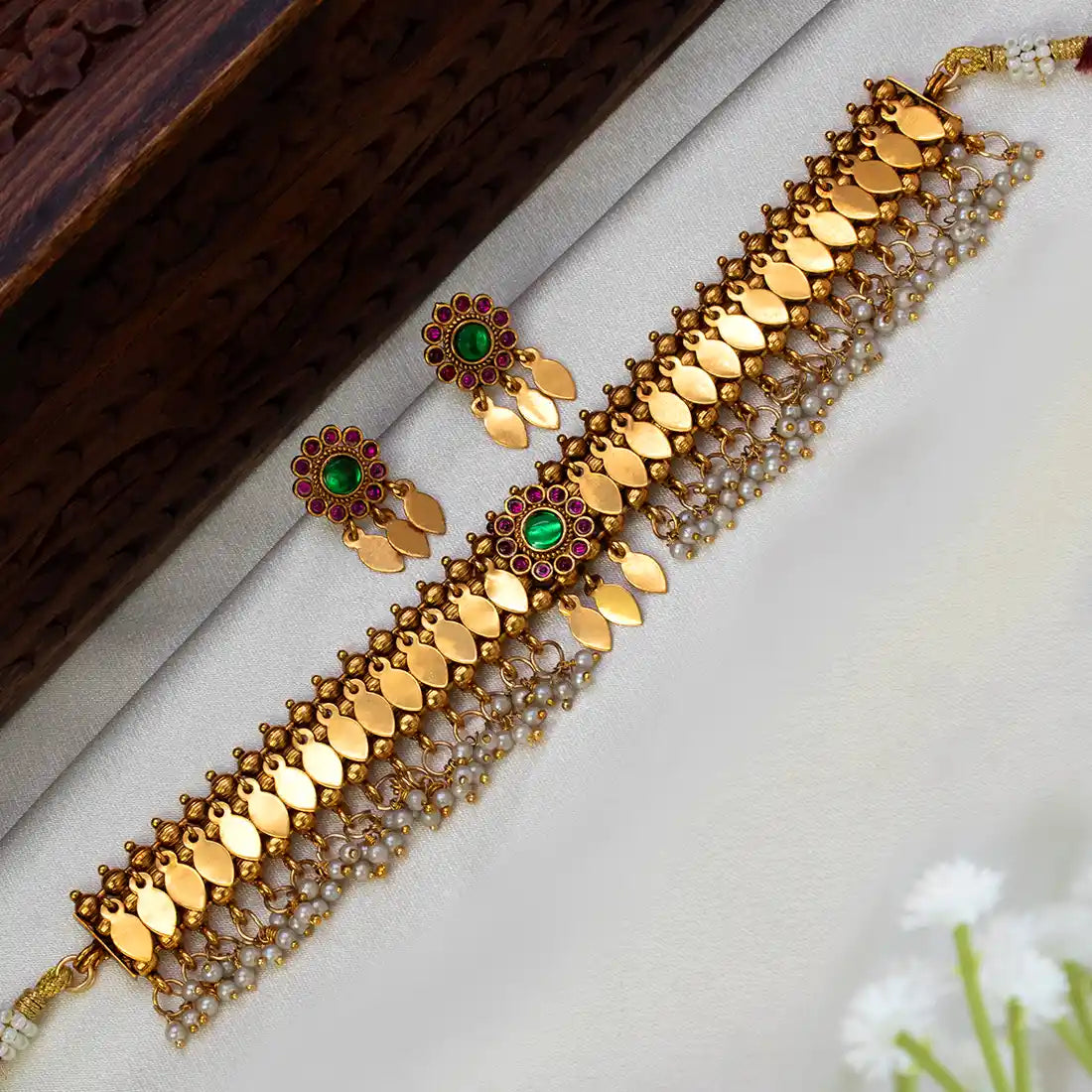 Antique Kemp Pearl Hanging Kerala Elakkathali Choker Set featuring gold-toned motifs and vibrant green and ruby stones.