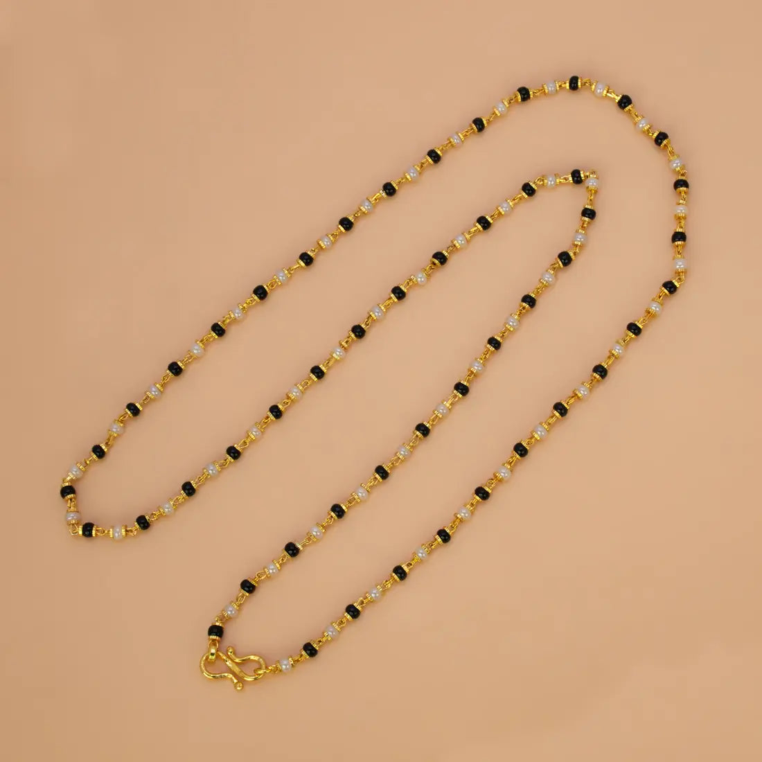 Gold Plated Black and White Pearl Chain Necklace for Women on a light background.