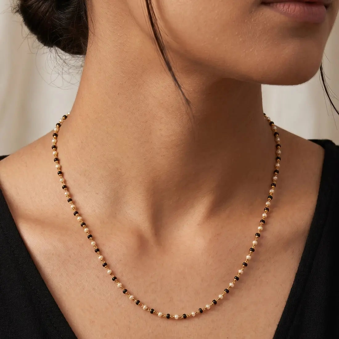 Gold Plated Black and White Pearl Chain Necklace for Women worn by a model.