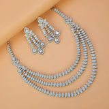 Rhodium Plated American Diamond necklace and earrings on a model against a beige background