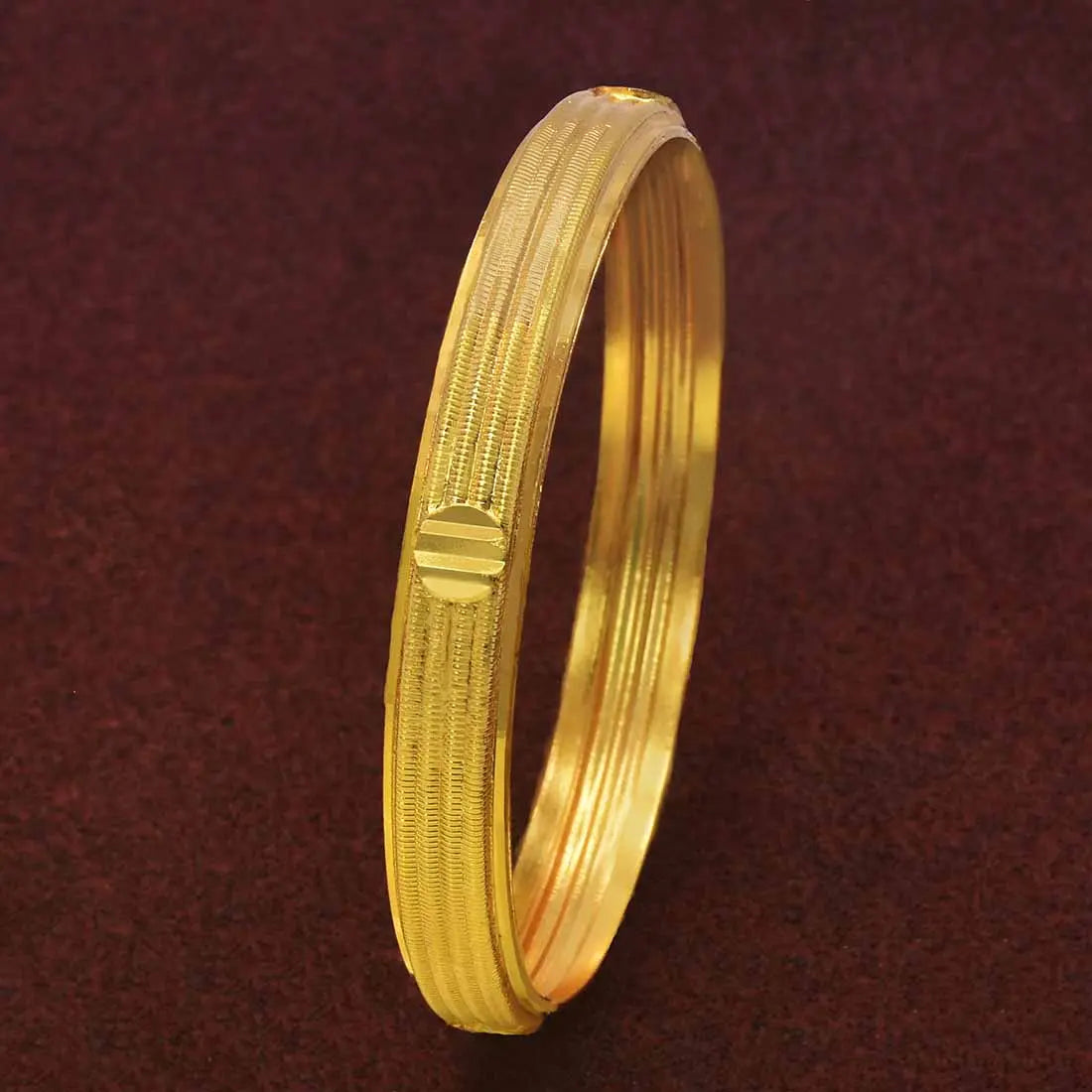 Contemporary Gold Plated Multi Spring Design Bangle on a dark background showcasing its elegant finish and intricate pattern.