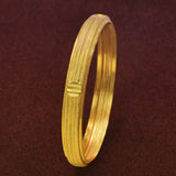 Contemporary Gold Plated Multi Spring Design Bangle on a dark background showcasing its elegant finish and intricate pattern.