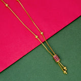 Elegant Gold Plated Cylindrical Stone Pendant Chain with ruby accent on vibrant pink and green background.