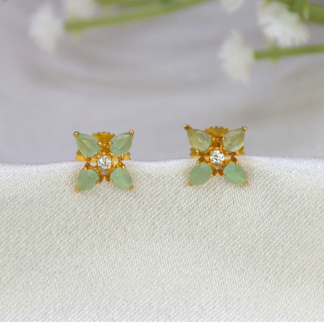 Gold-Plated Mint Green Flower CZ Ear Studs featuring mint green stones and a sparkling white CZ stone.