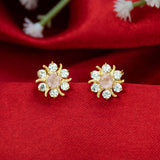 Gold Plated Pastel Central Stone CZ Flower Studs with pastel pink center and sparkling stones on red fabric.