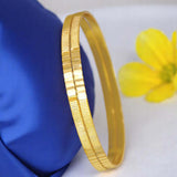 Stylish Gold Plated Daily Wear Plain Bangles displayed on a blue fabric with a flower.