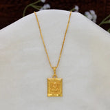 Devotional Gold Plated Rectangle Ganesha Pendant necklace featuring an embossed deity charm, displayed on a white jewelry bust.