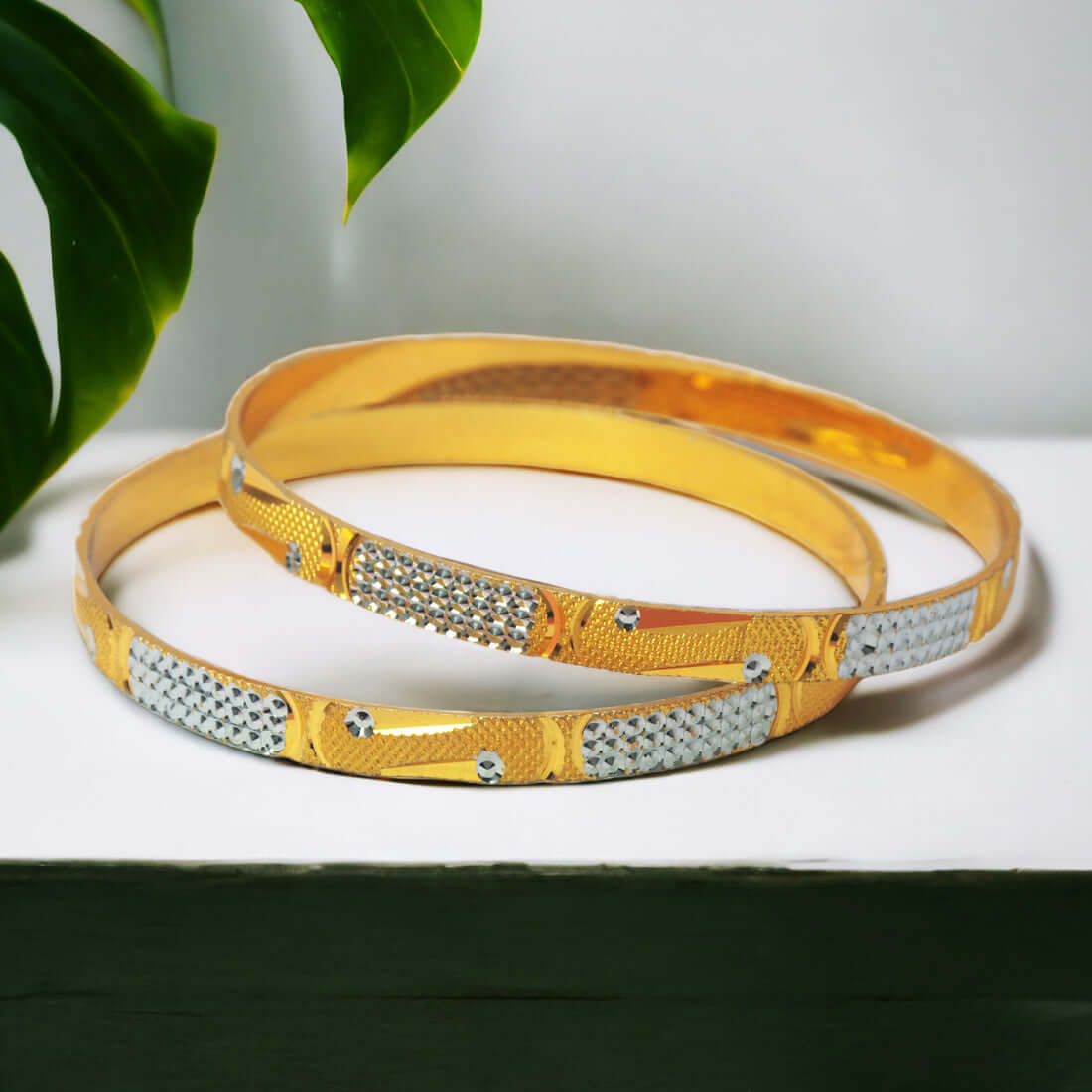 Splendid Two-Tone Gold Plated Bangles featuring shimmering gold and silver accents, perfect for elegant styling.