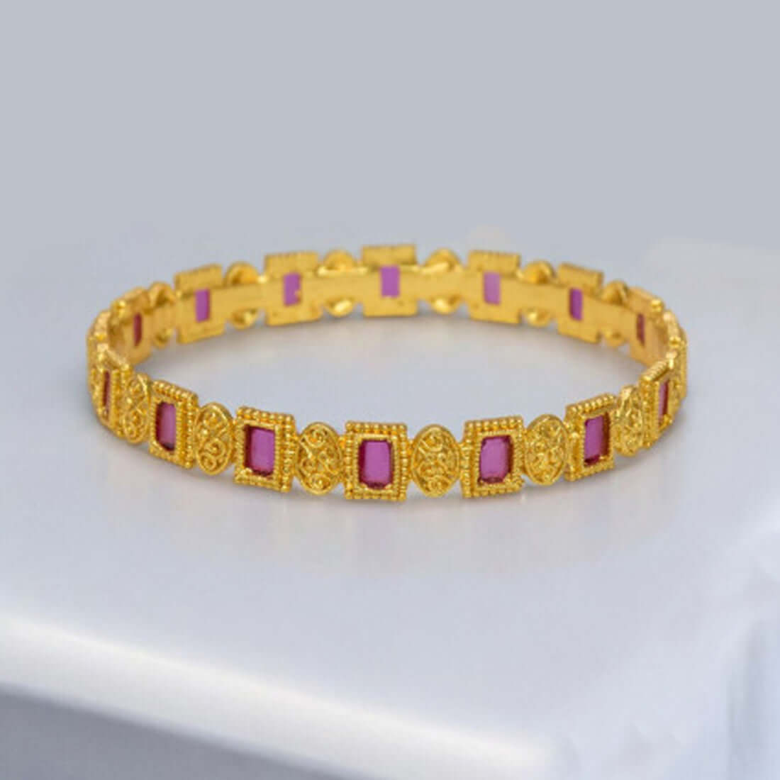 Elegant Rectangle Ruby Stone Bangle featuring intricate gold detailing and vibrant ruby stones.