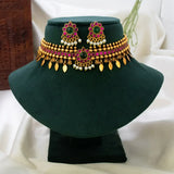 A traditional Indian Antique Kemp Elakkathali Choker Necklace Set with green stones, pink stones, and white pearl accents, displayed on a dark green velvet jewelry bust.