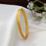 Gold-Plated Matte Designer Bangles with a textured surface, elegantly catching the light on a soft fabric background.