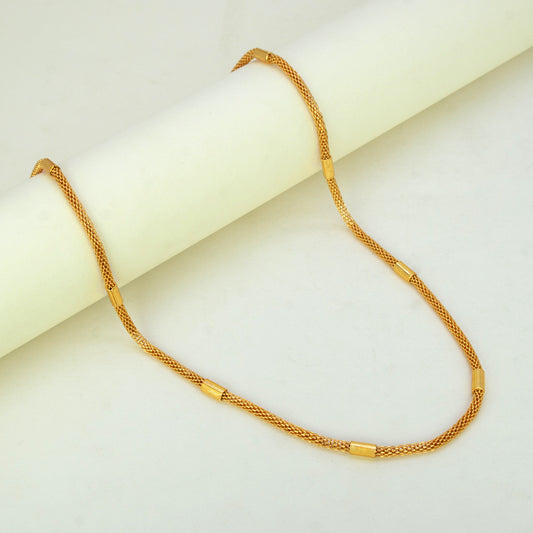 Elegant Gold Plated Mesh Pipe Chain displayed elegantly on a smooth surface, highlighting its delicate design and cylindrical accents.