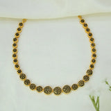 A Gold-Plated Round Design Stone Necklace featuring circular disc charms paved with small black CZ stones on a soft white fabric background.