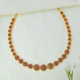 A Gold-Plated Round Design Stone Necklace featuring small ruby stones studded in clusters displayed on a soft white fabric background.