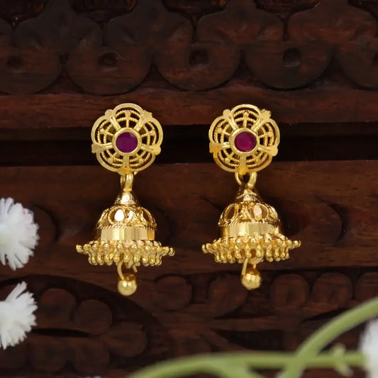 Small Gold Plated Ruby Stone Jhumka Earrings with floral design and ruby accent, showcasing delicate gold filigree.