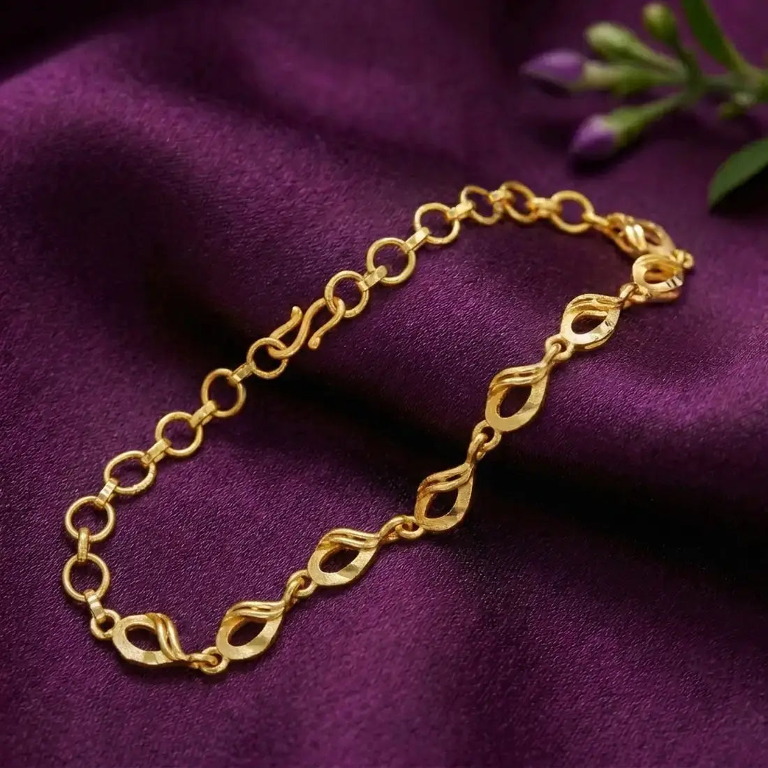 Lightweight Gold-Plated Designer Link Bracelet on a purple fabric background, showcasing elegant link detailing.