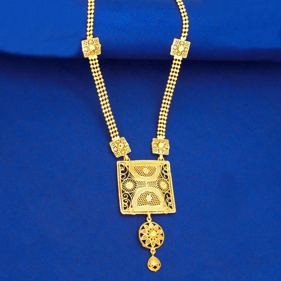 Matte Gold Plated Traditional Square Pendant Necklace with textured chain and floral accents on blue background.
