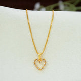 A Gold-Plated Baguette-Cut Cubic Zirconia Heart Pendant with chain with a textured, open heart design, displayed on a white jewelry bust.