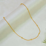 Gold-Plated Beaded Curb Link Baby Chain necklace with evenly spaced small gold beads, displayed on a soft, light-colored fabric background.