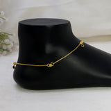 Gold-Plated Black Crystal Gold Bead Anklets with a small heart-shaped charm and a tiny dangling bead, displayed on a black mannequin foot against a soft white fabric background.
