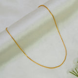 Gold-Plated Box Chain for Kids resting on a soft fabric background, showcasing its sleek geometry and shine.