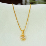 A gold chain necklace with a Gold-Plated Floral CZ Stone Pendant, displayed on a white jewellery bust.
