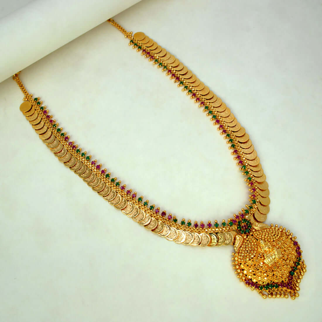 Gold Plated Ruby Emerald Lakshmi Kasu Haram With Pendant showcasing ornate design and vibrant stones.