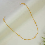 A delicate Gold Plated Beaded Box Chain for Babies with small, evenly spaced textured gold beads, displayed on a soft, draped white fabric background.