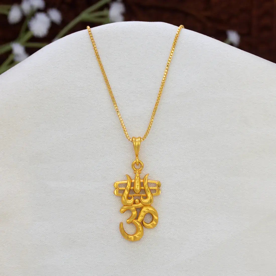 Gold Plated Om Trishul Mahadev Shiva Pendant necklace displayed on a white jewelry bust, with a textured gold chain and an Om symbol pendant.