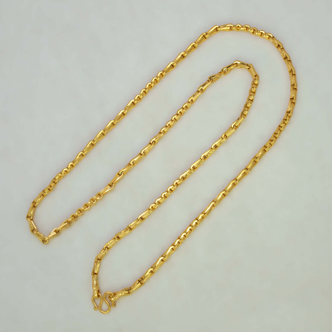 Stylish Gold Plated Cutting Bhanu Priya Chain displayed on a flat surface, showcasing its elegant design and polished finish.