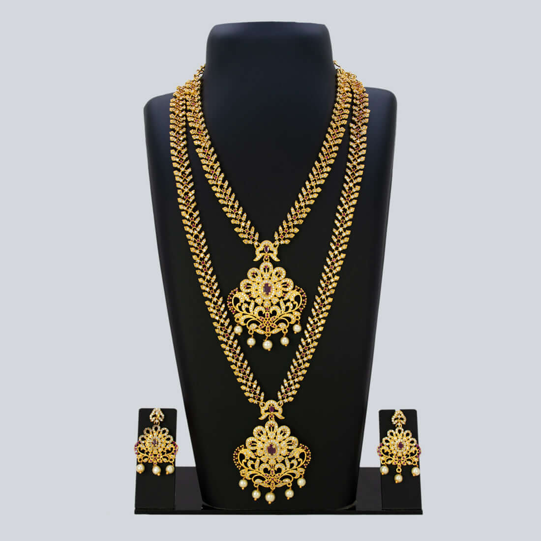 Gorgeous CZ Ruby Floral Wedding Jewellery Set featuring gold-plated necklaces and matching earrings.