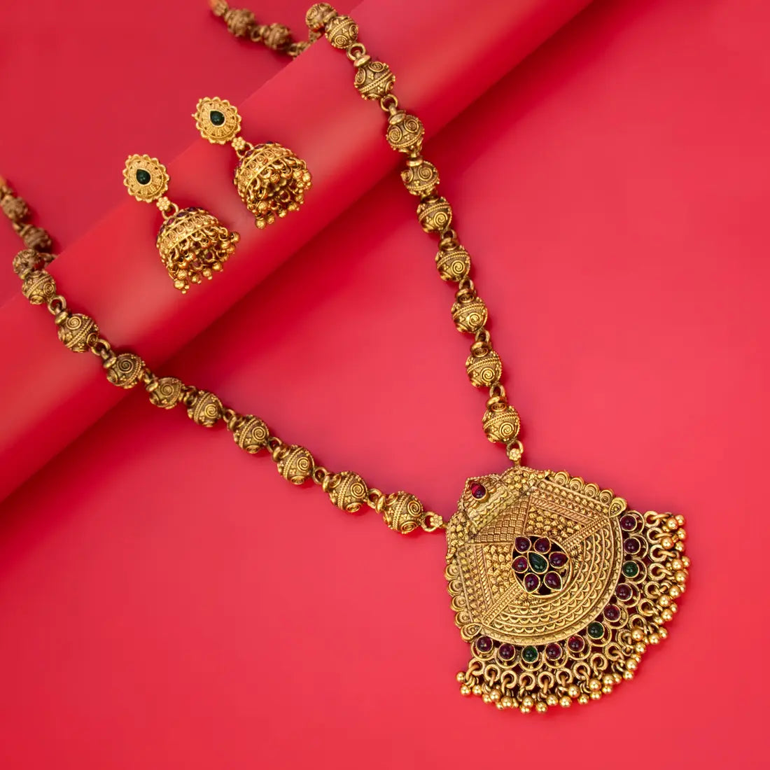 Antique Matte Gold Beads Long Chain Necklace Set featuring ornate pendant and jhumka earrings on a vibrant background.